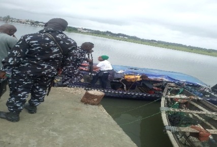 A member of the field team pictured beside a boat.